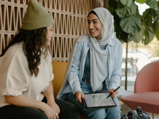 a couple of women sitting on a couch