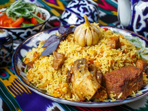 a plate of rice with meat and vegetables