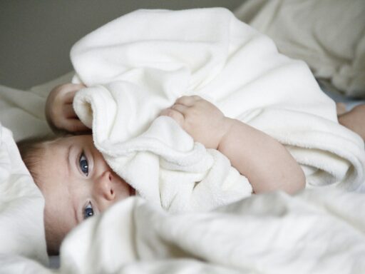 baby laying on bed